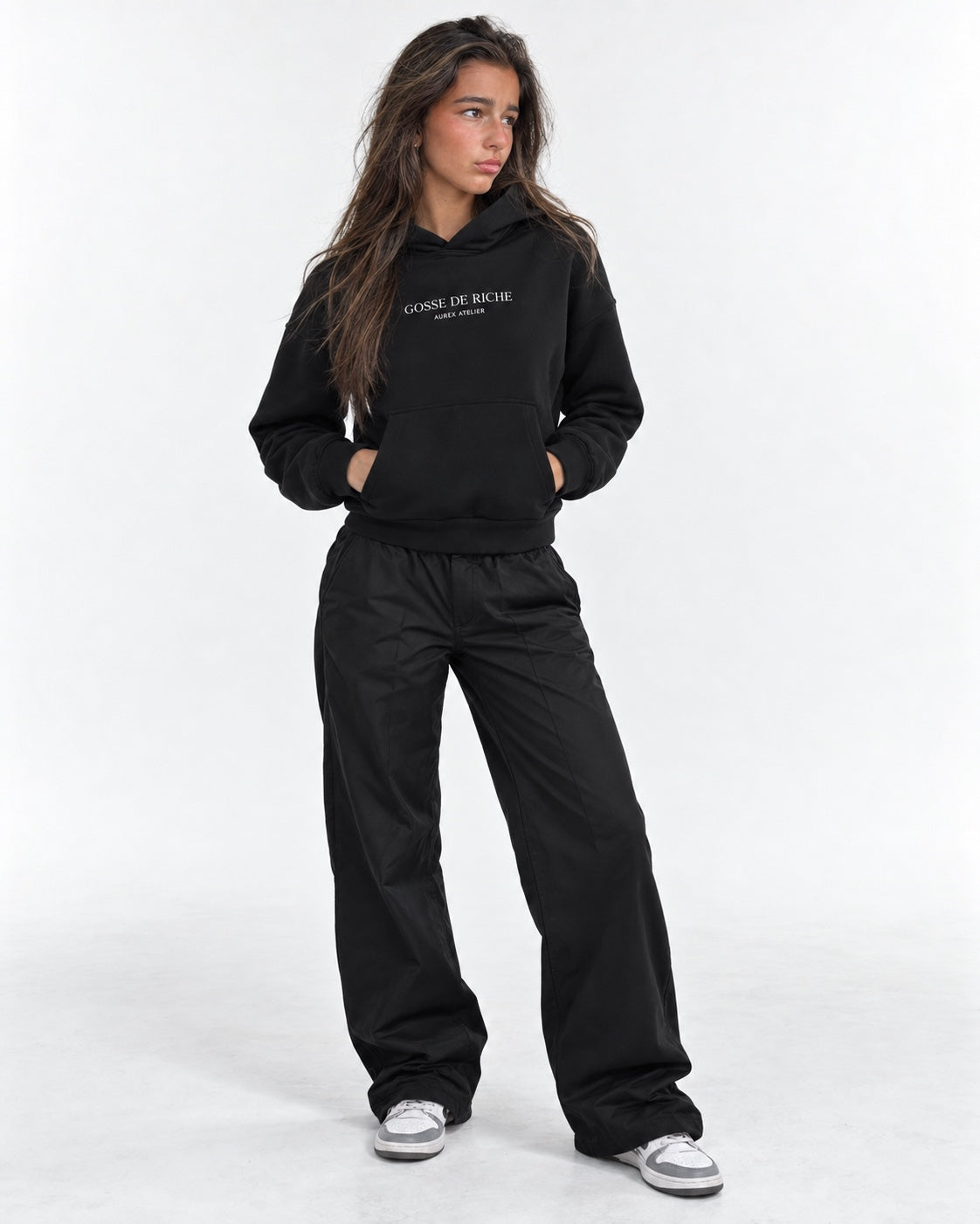 Layla wearing the GDR Hoodie on a white studio background